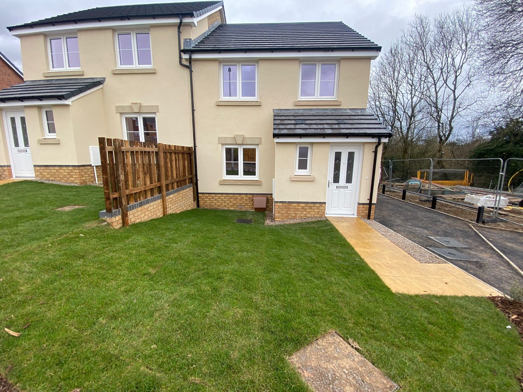 An image of the front of a house and garden