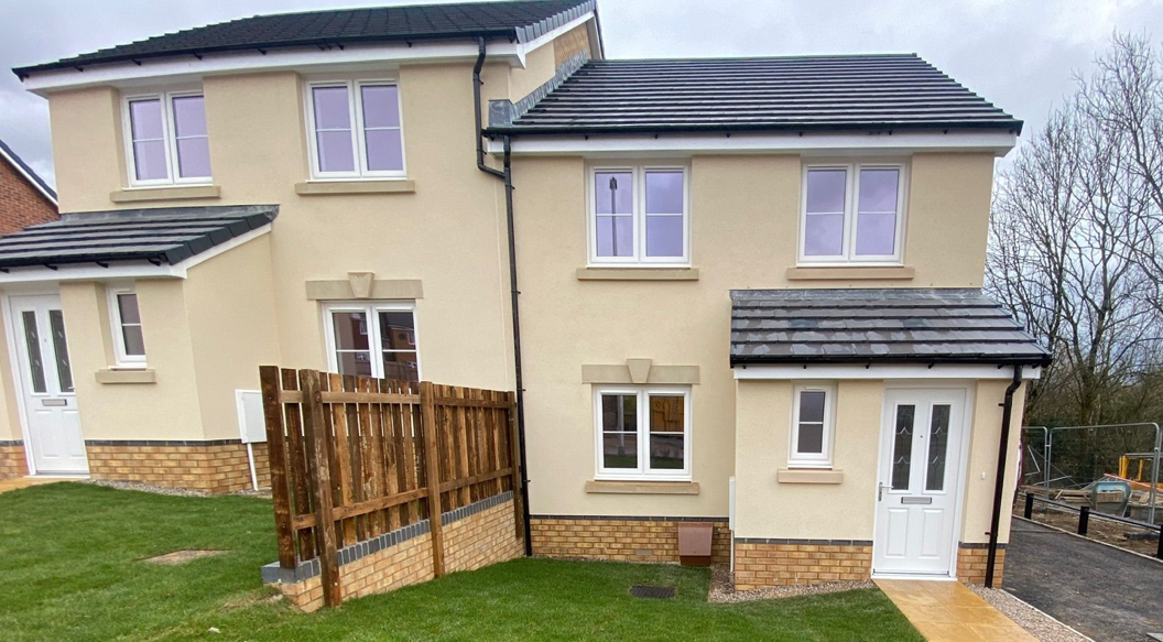 An image of the front of a house with cream exterior